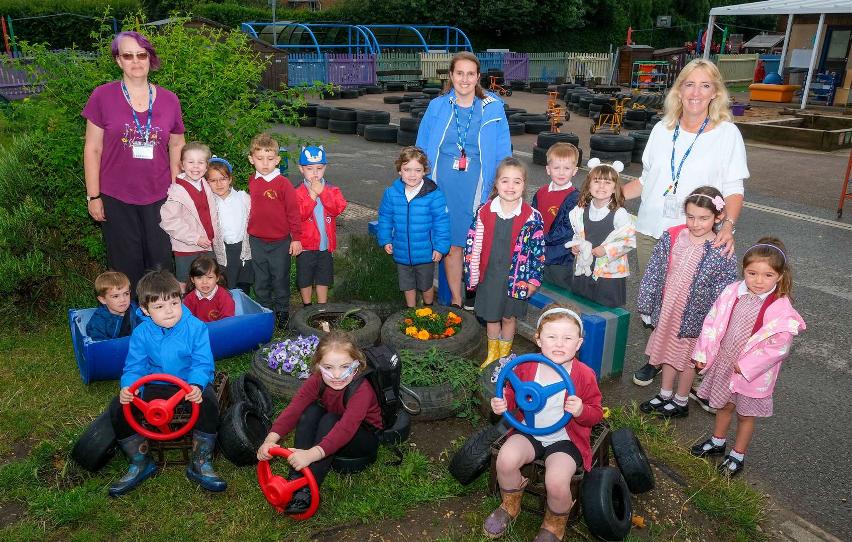 Spurcroft staff and pupils standing in their restored Outdoor Learning Area