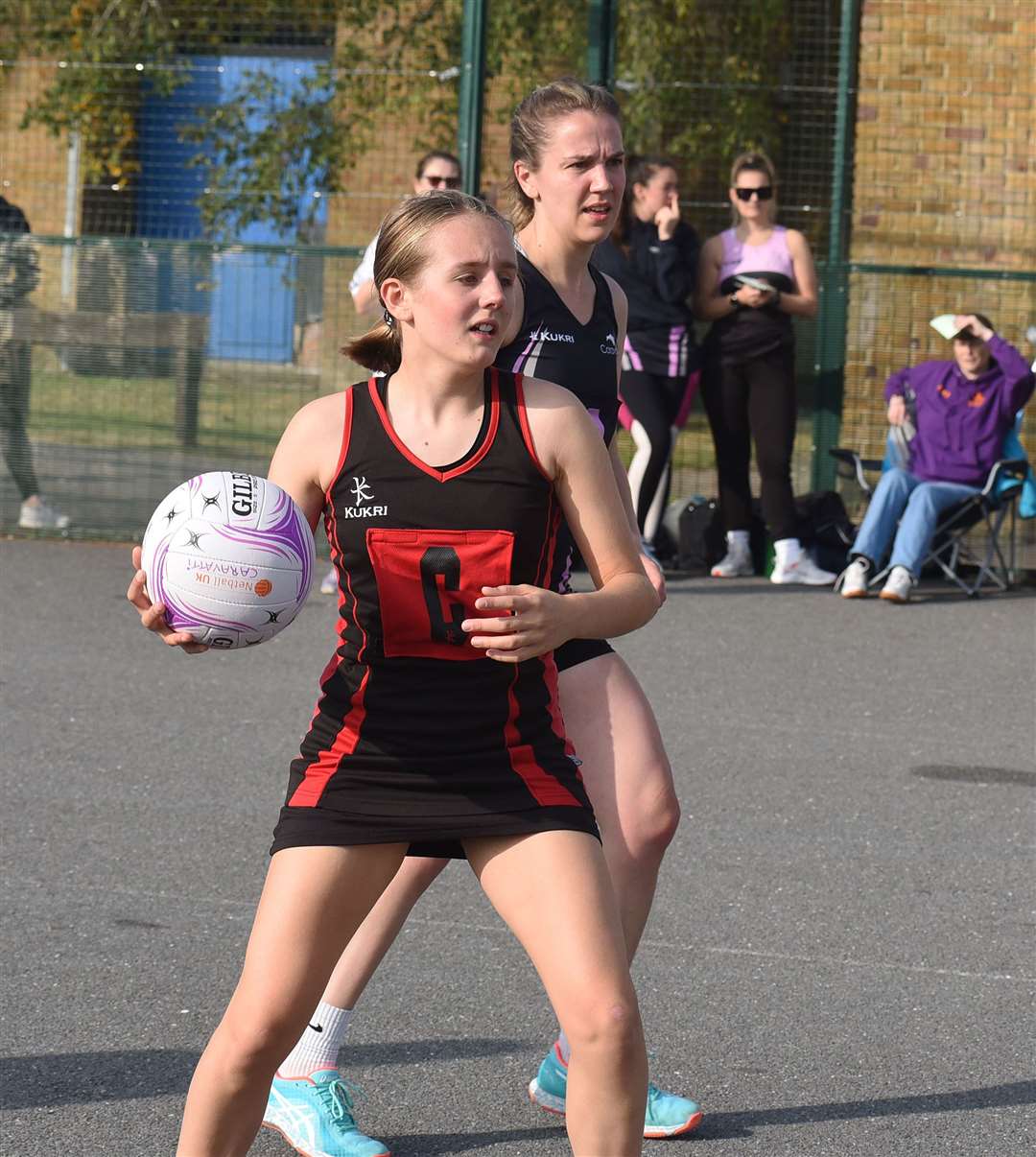 A Newbury player is in control of the ball