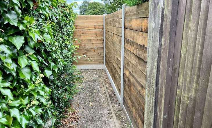 The wooden fence erected at the bottom of the pathway off Beverley Close accessing the Memorial Playing Fields, pictured in July