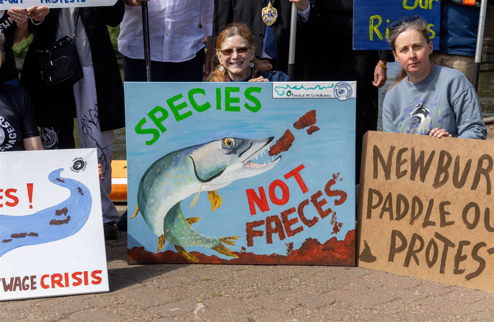 Handmade signs at the Paddle Out protest against sewage spills