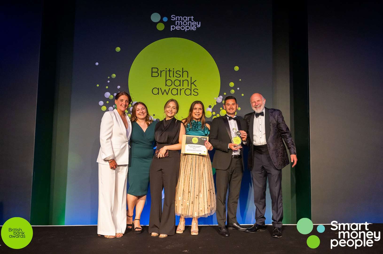 The Newbury Building Society Team receive their Best Building Society award from ceremony host, comedian Simon Evans