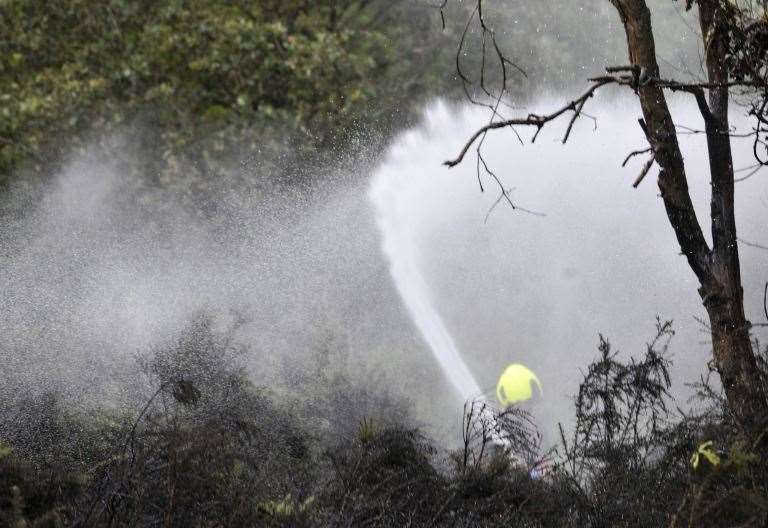 Fire fighters use main water jet to fight blaze. Credit: Paul King