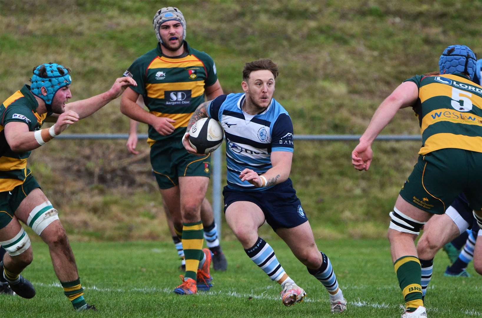 A Newbury player drives forward