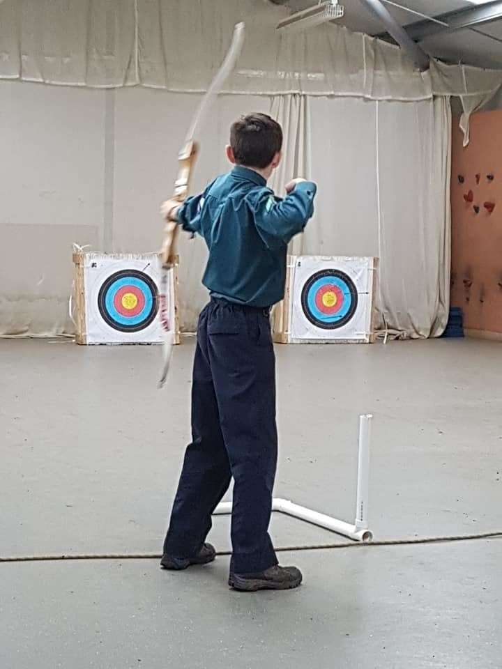 A scout doing archery