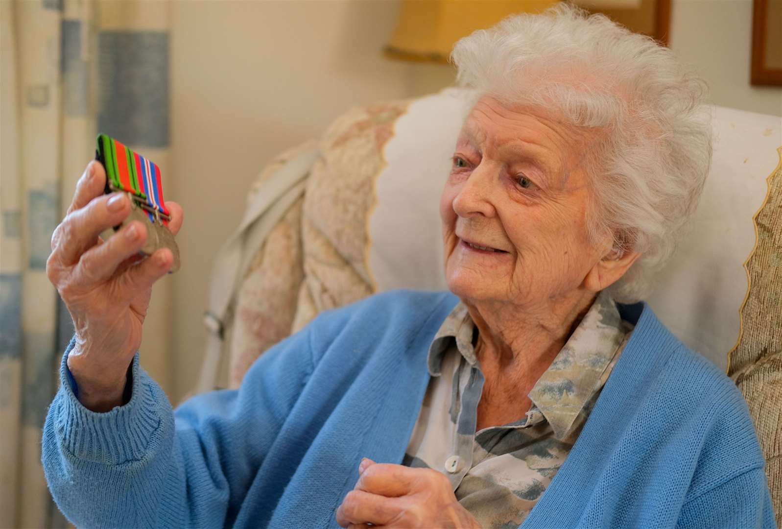 Mary inspecting her wartime medals