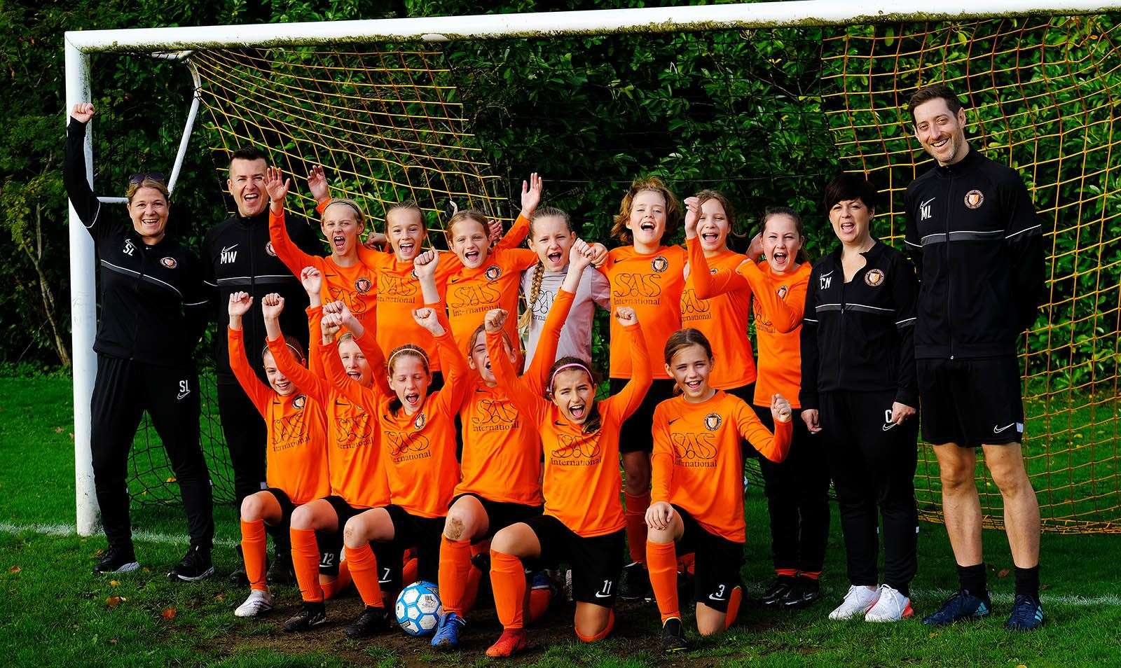 Matt Winch to the left of the U11 girls squad with Manager Claire on the right