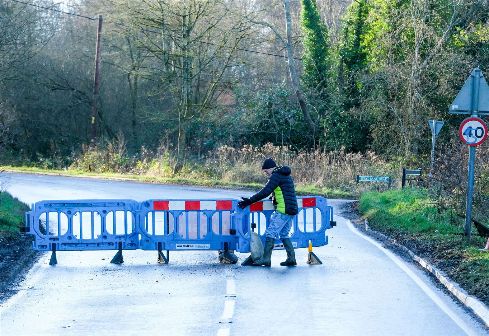 Resident Don Robinson putting a moved barrier back on the road