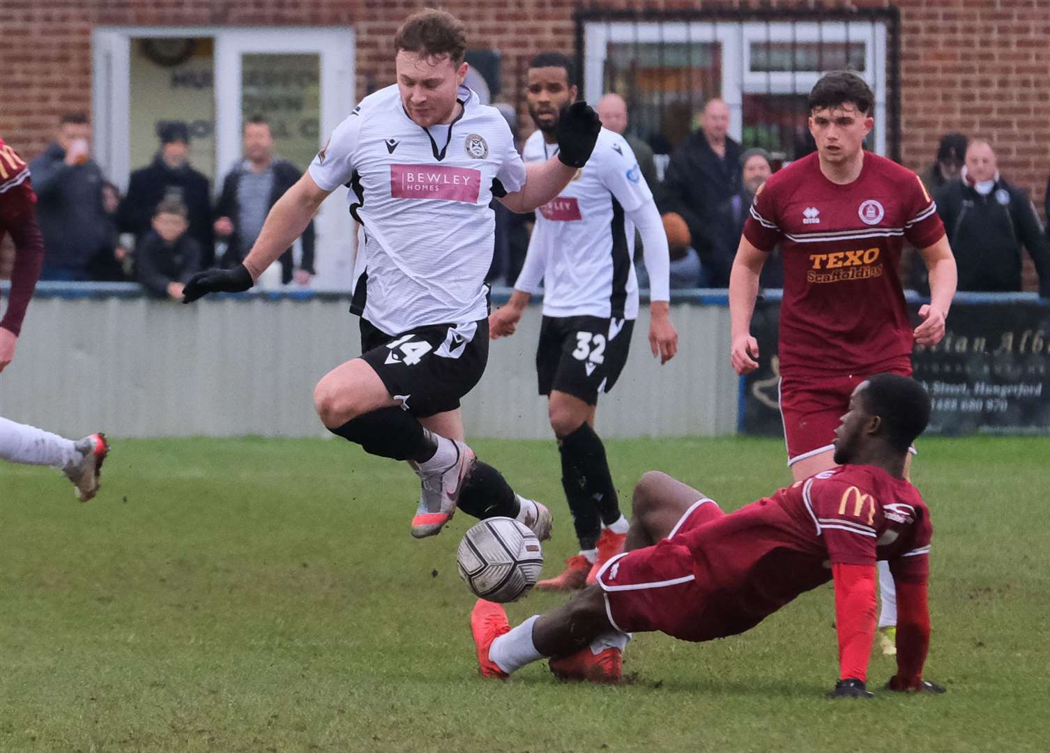 Jake Evans challenges for possession