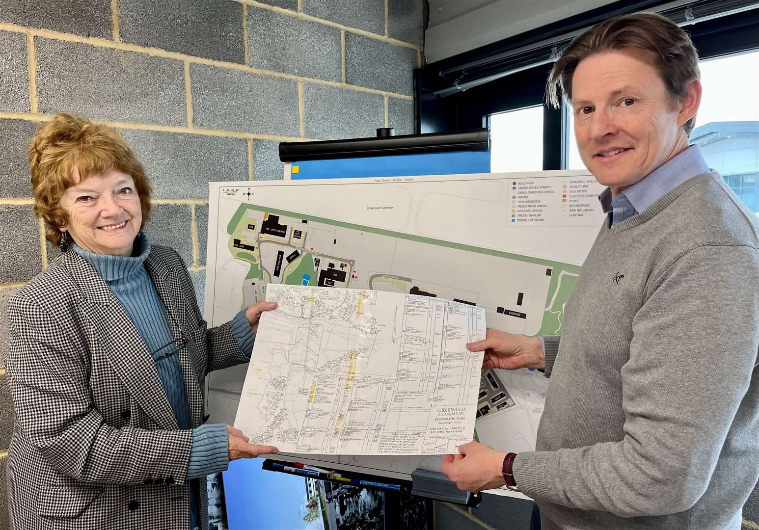 Liz Chaplain handing a copy of the map to Rupert Holtby, Estates Manager at Greenham Business Park