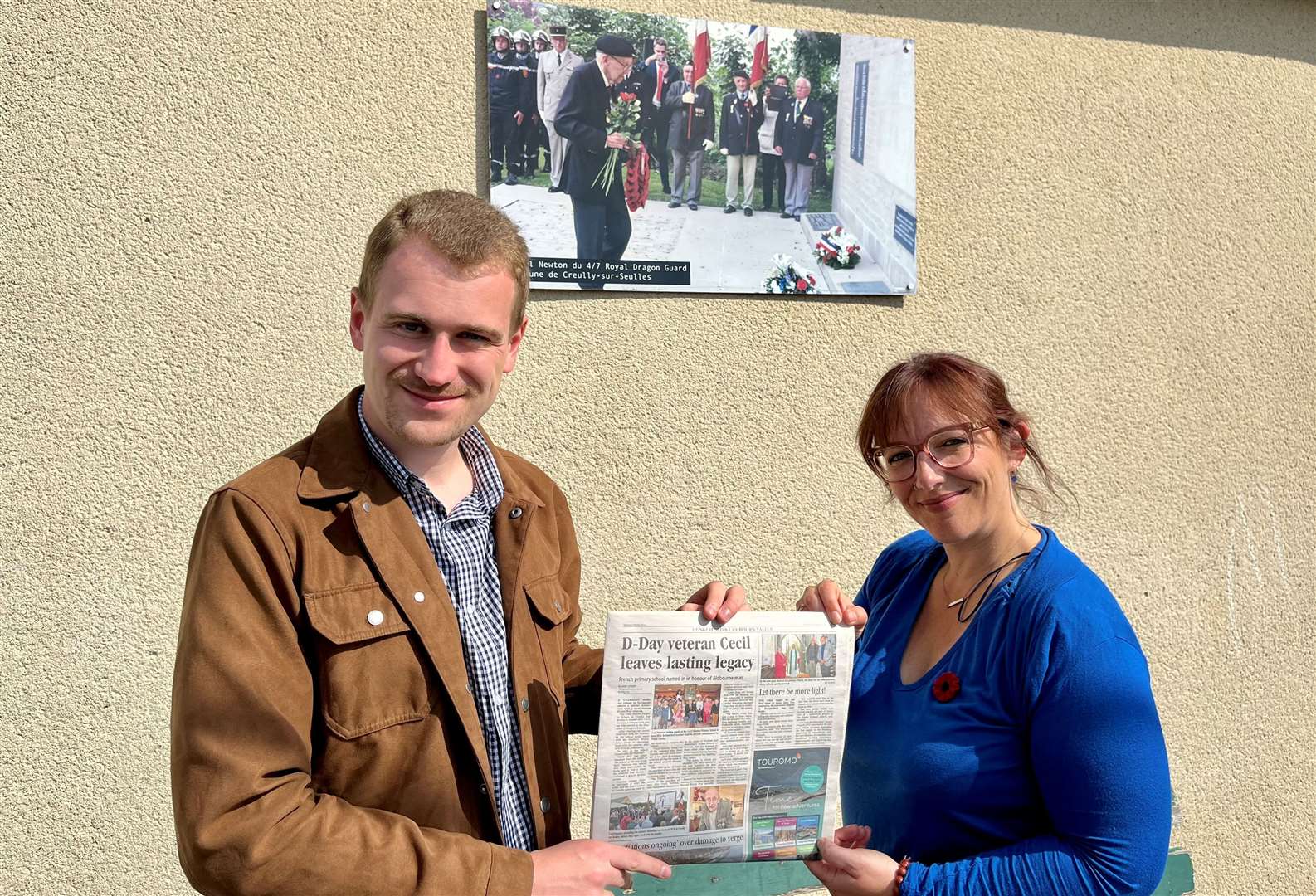 Mirek Gosney and headteacher, Jacinta Chaumeron, holding a copy of the Newbury Weekly News about Cecil Newton. Credit: Geoff Gosney