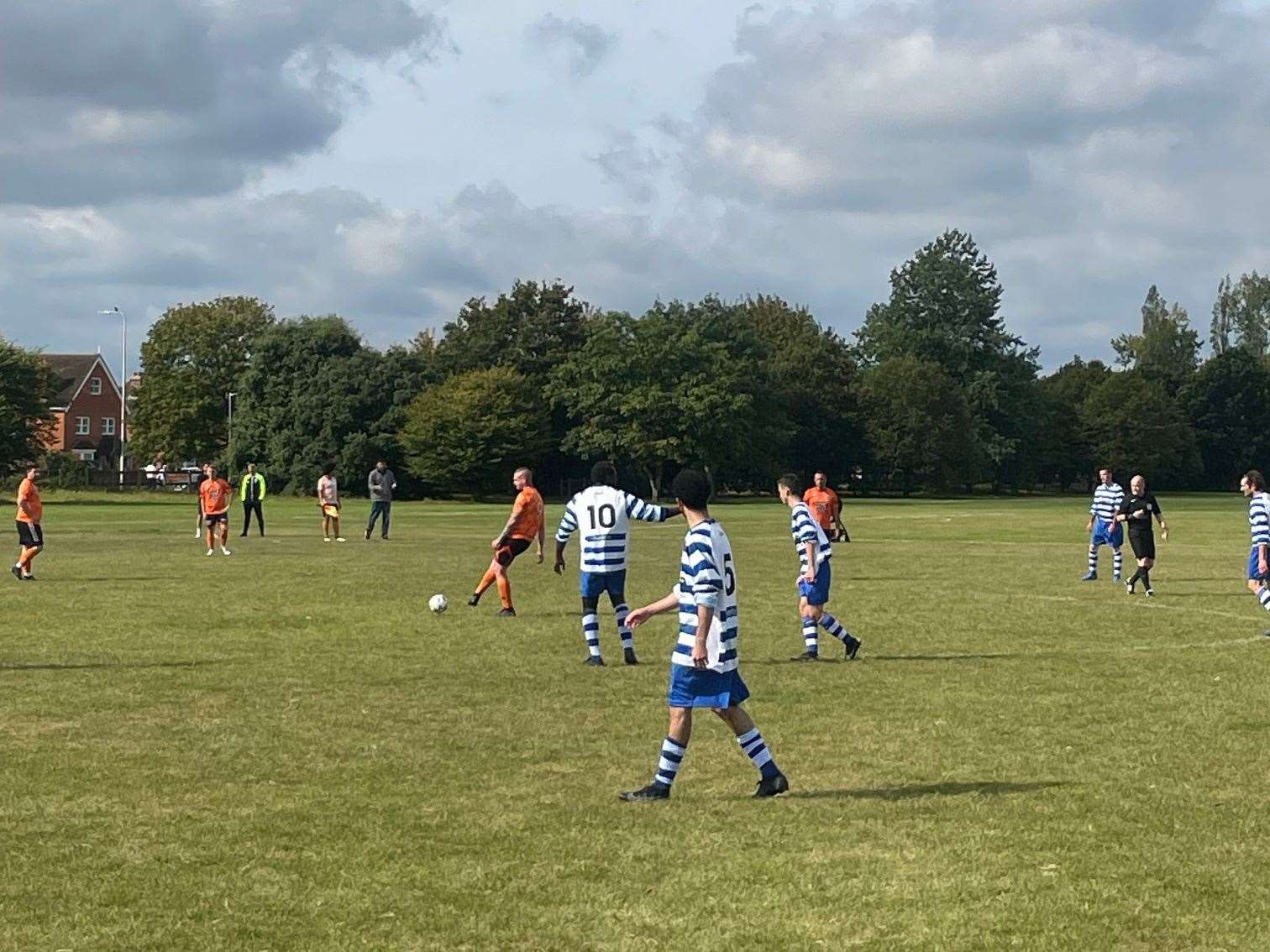 The Crickets AFC (blue & white) host The Plough on the Green FC (orange)
