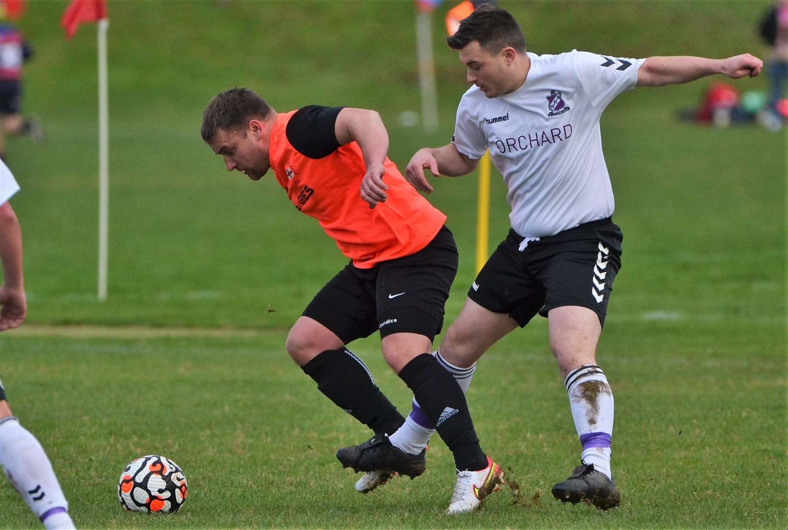 Two players challenge for the ball
