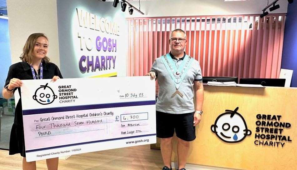 Worshipful master, Ian Atkinson, presenting the cheque to GOSH representative, Katie Richardson