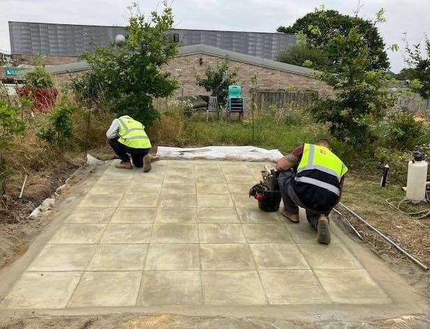 The finishing touches are put in place on a courtyard area at Theale Green School