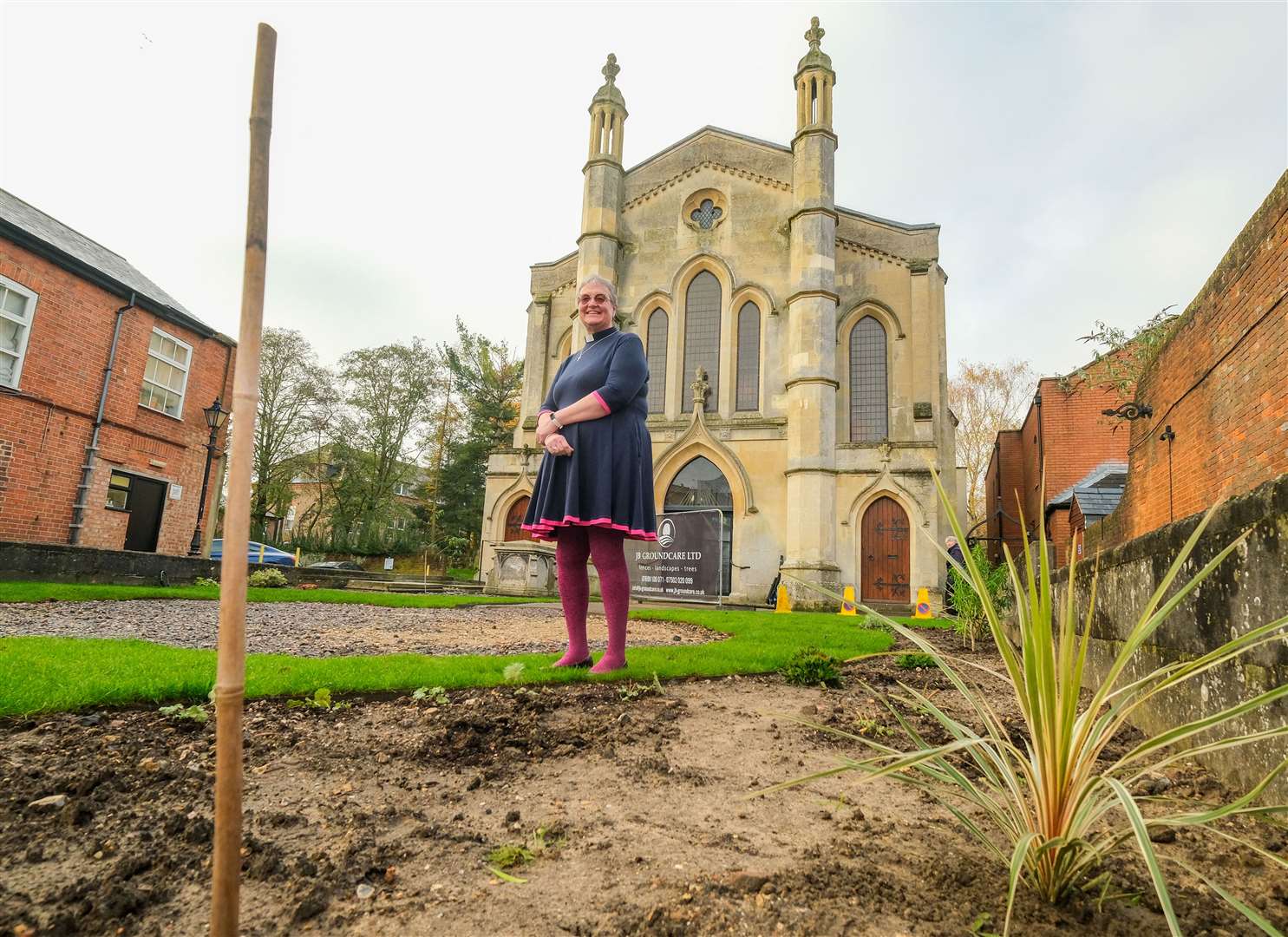 Rev Rachel Borgars standing on the damaged front lawn at Newbury Methodist Church