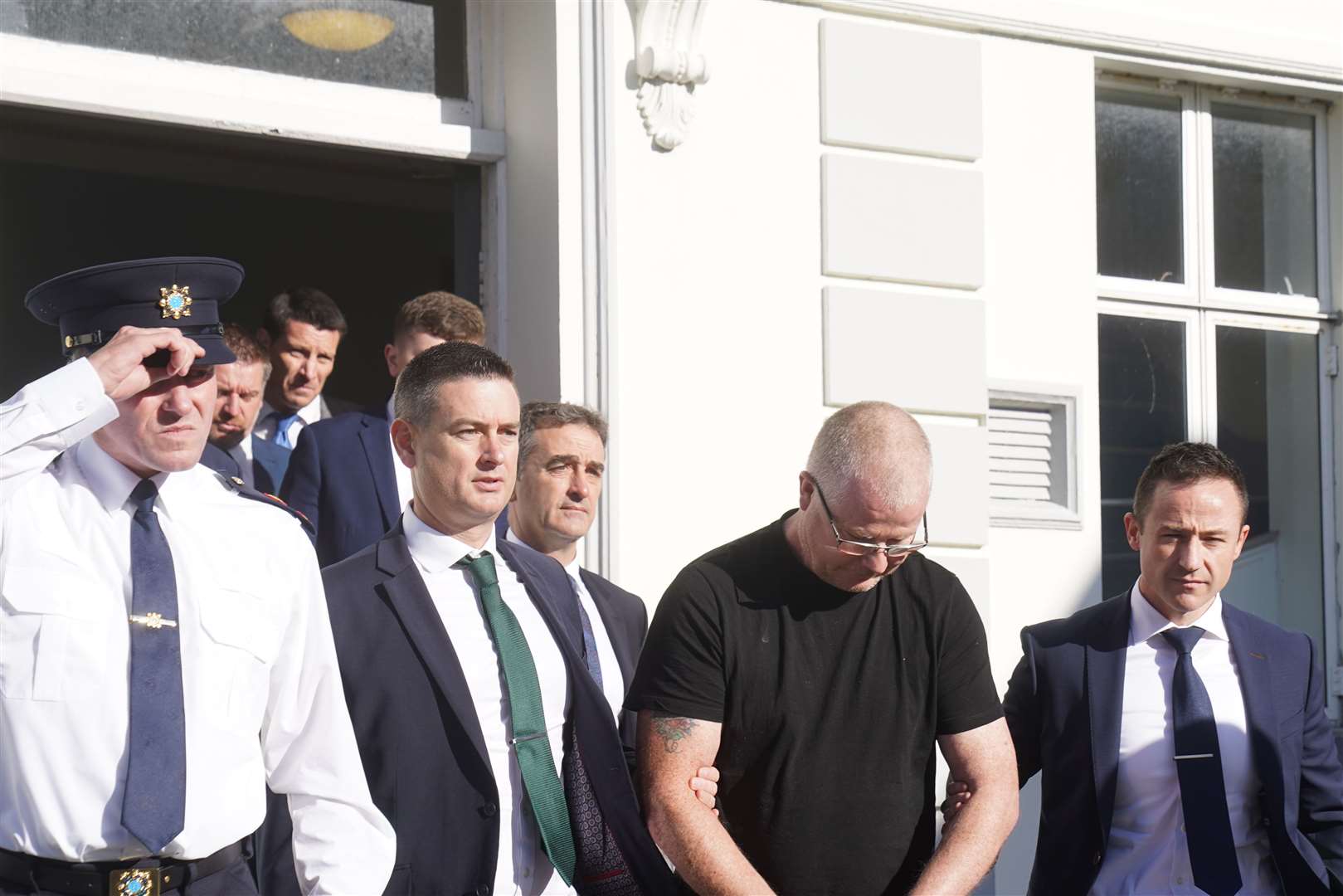 Richard Satchwell (second right) leaves the District Court in Cashel, Co Tipperary, after being charged in connection with the murder of his wife Tina Satchwell (Brian Lawless/PA)