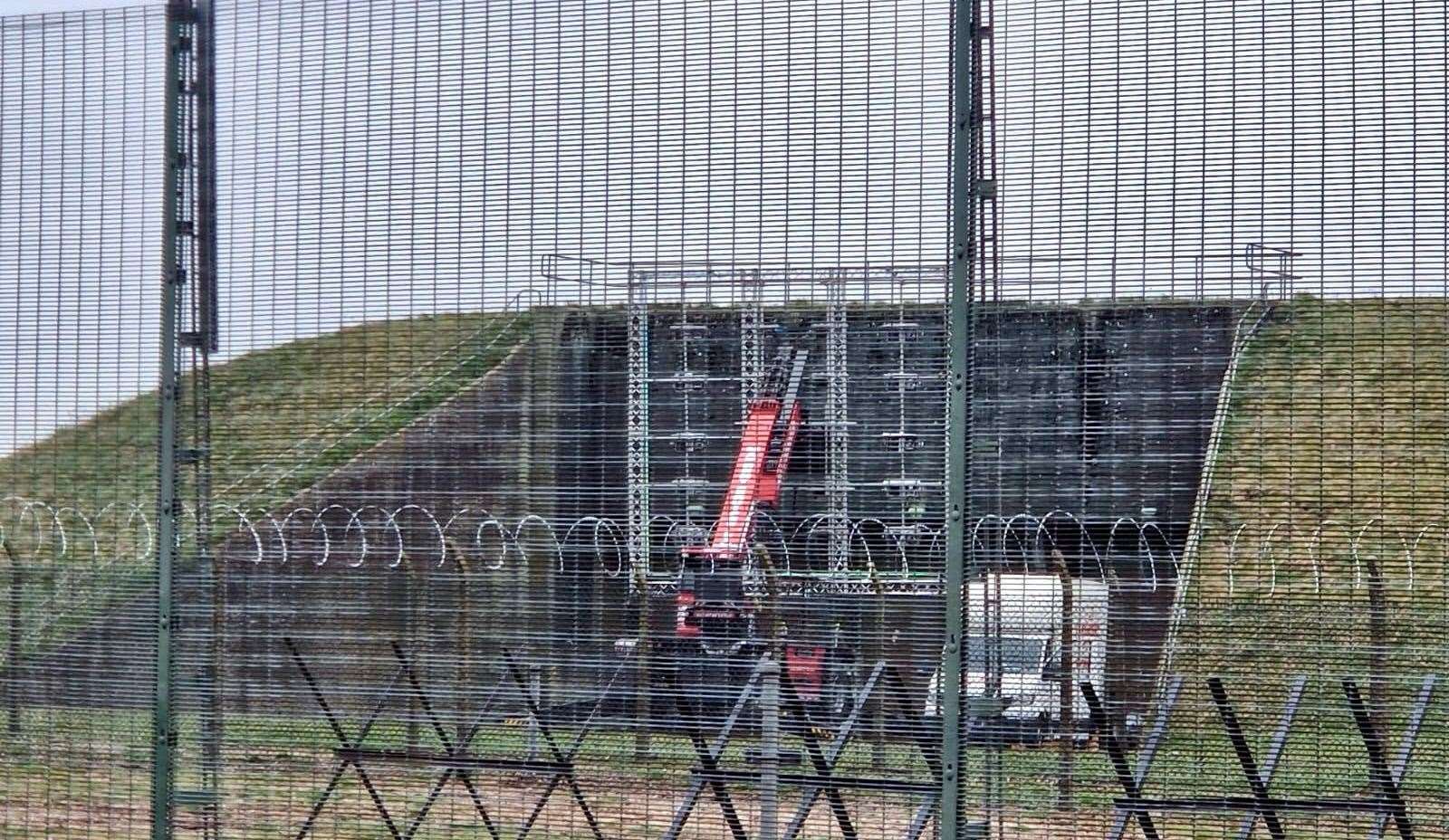 Crew rigging a set outside one of the former GAMA shelters