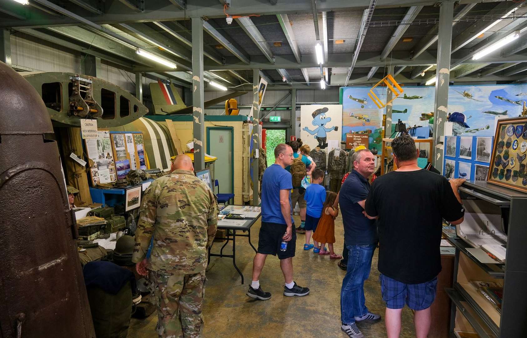 Visitors and service personell explore inside the Museum