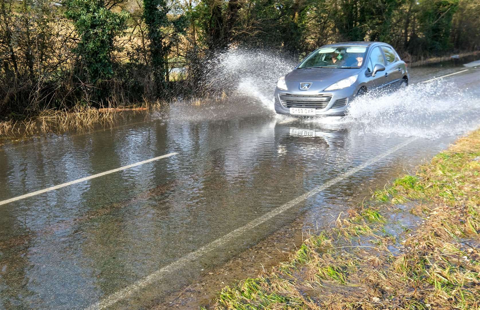 Potholes covered in flood water along B4494