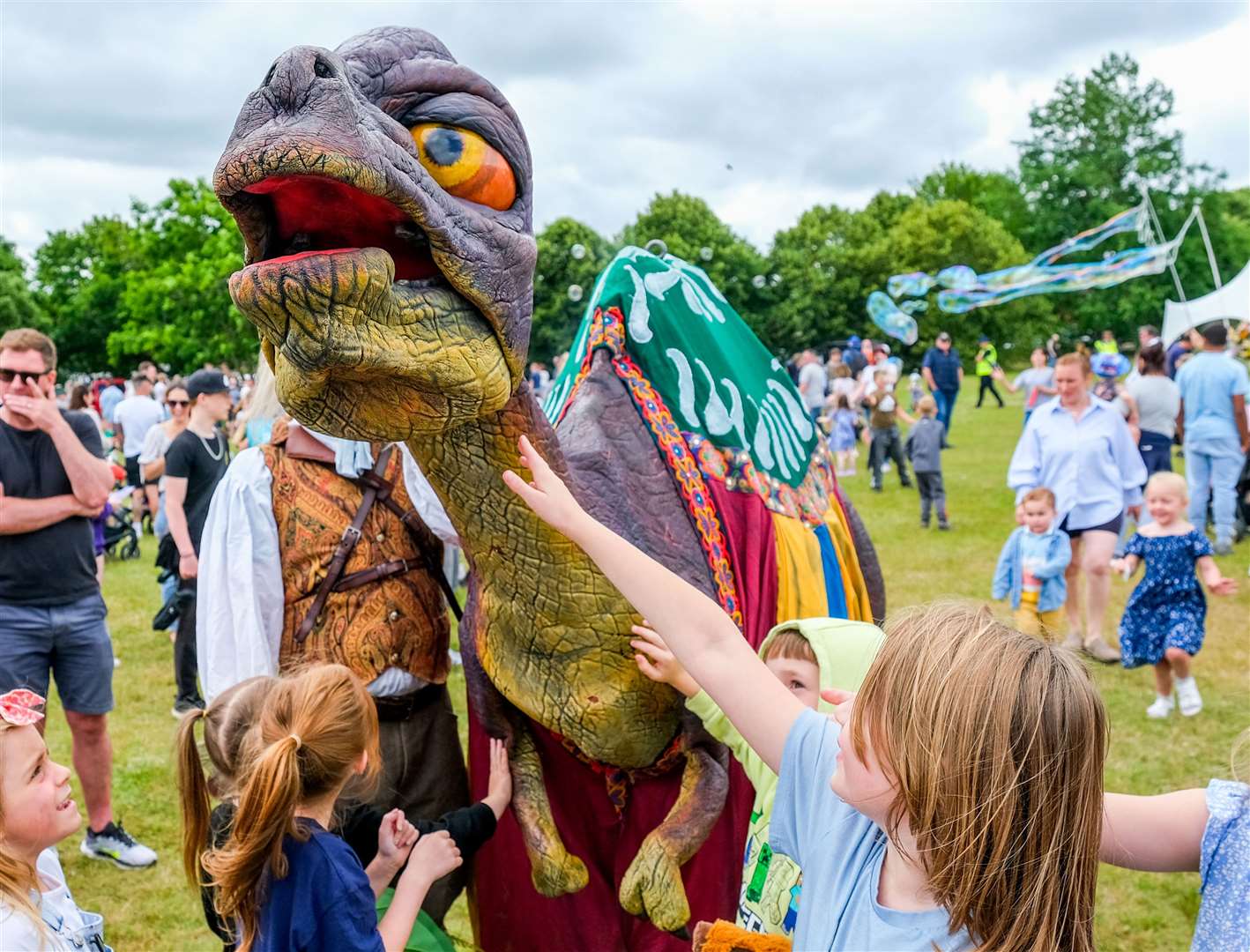 Children petting the dinosaur at Thatcham Family Fun Day
