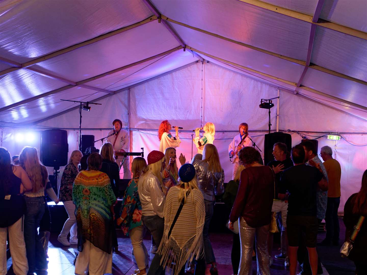 Friday night and the lights are low - ABBA tribute act rocks the marquee. Credit: Robert Elliott