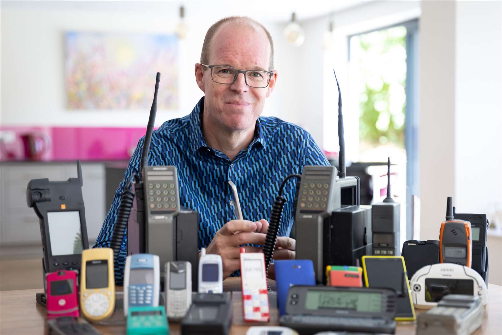 Founder of the Mobile Phone Museum, Ben Wood, with some of the collection
