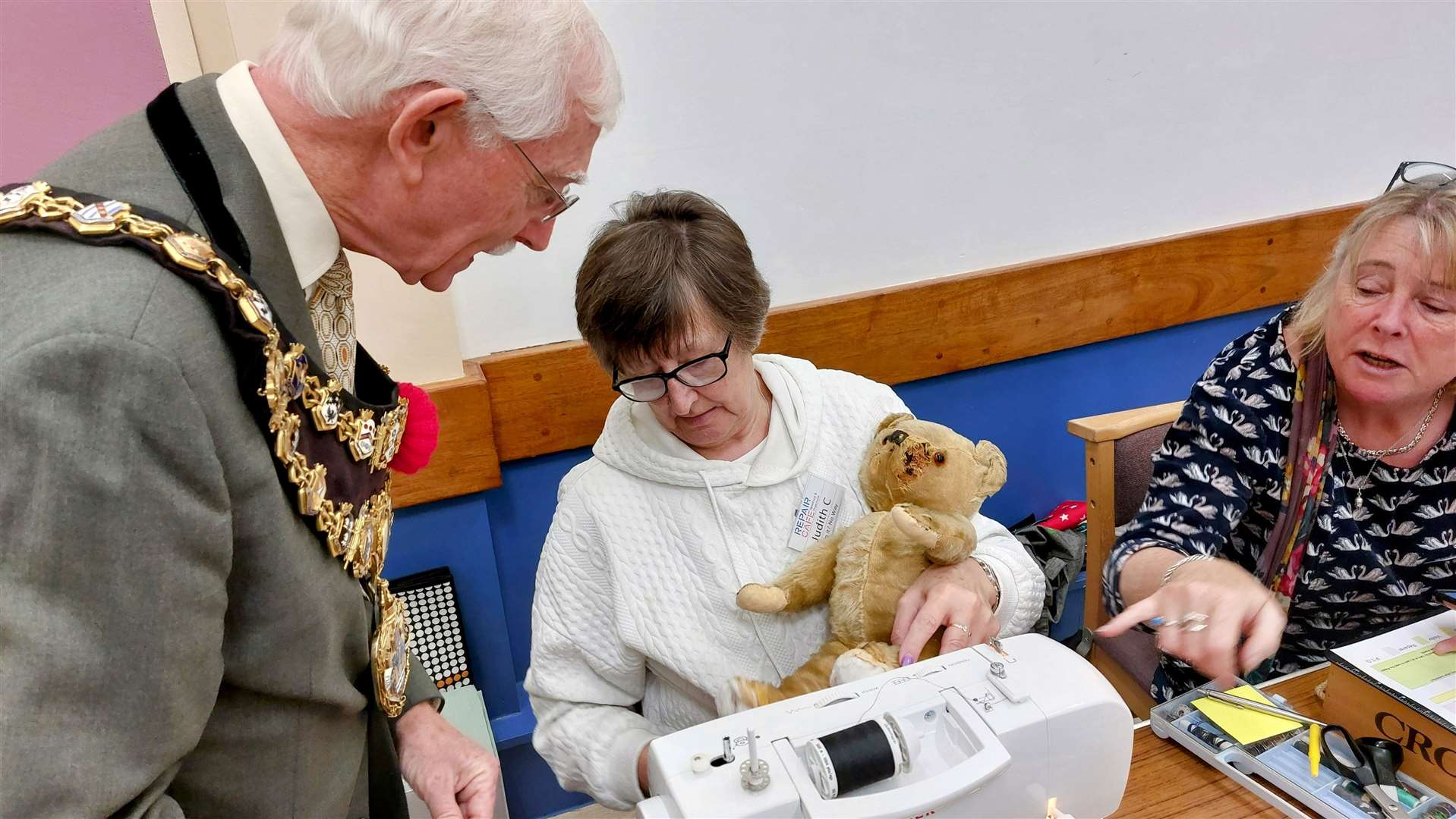 Mr Moore looking at an 83-year old teddy bear that was in to be repaired