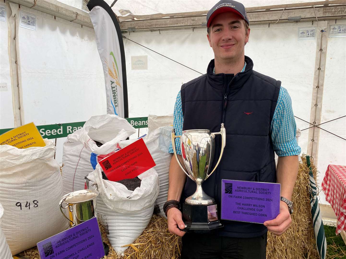 Josh Plank with the cups he won on behalf of Chilton Estates in the grain contests. His rape seed and winter wheat were deemed to be the best at the 2024 Newbury Show