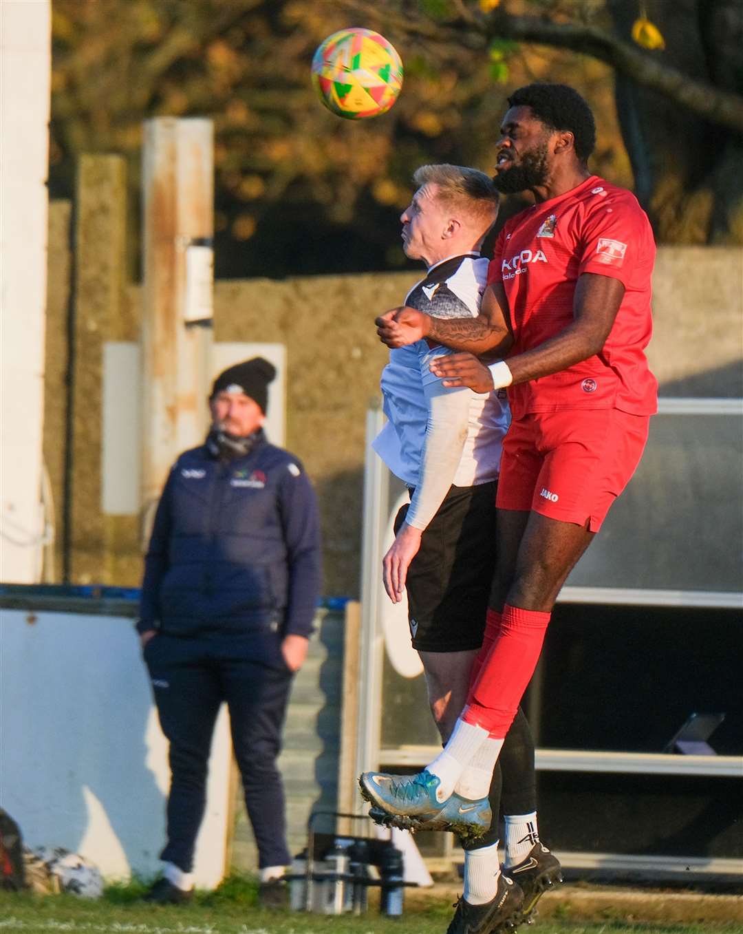 Joe Shepherd challenges for a header with Henry Lukombo