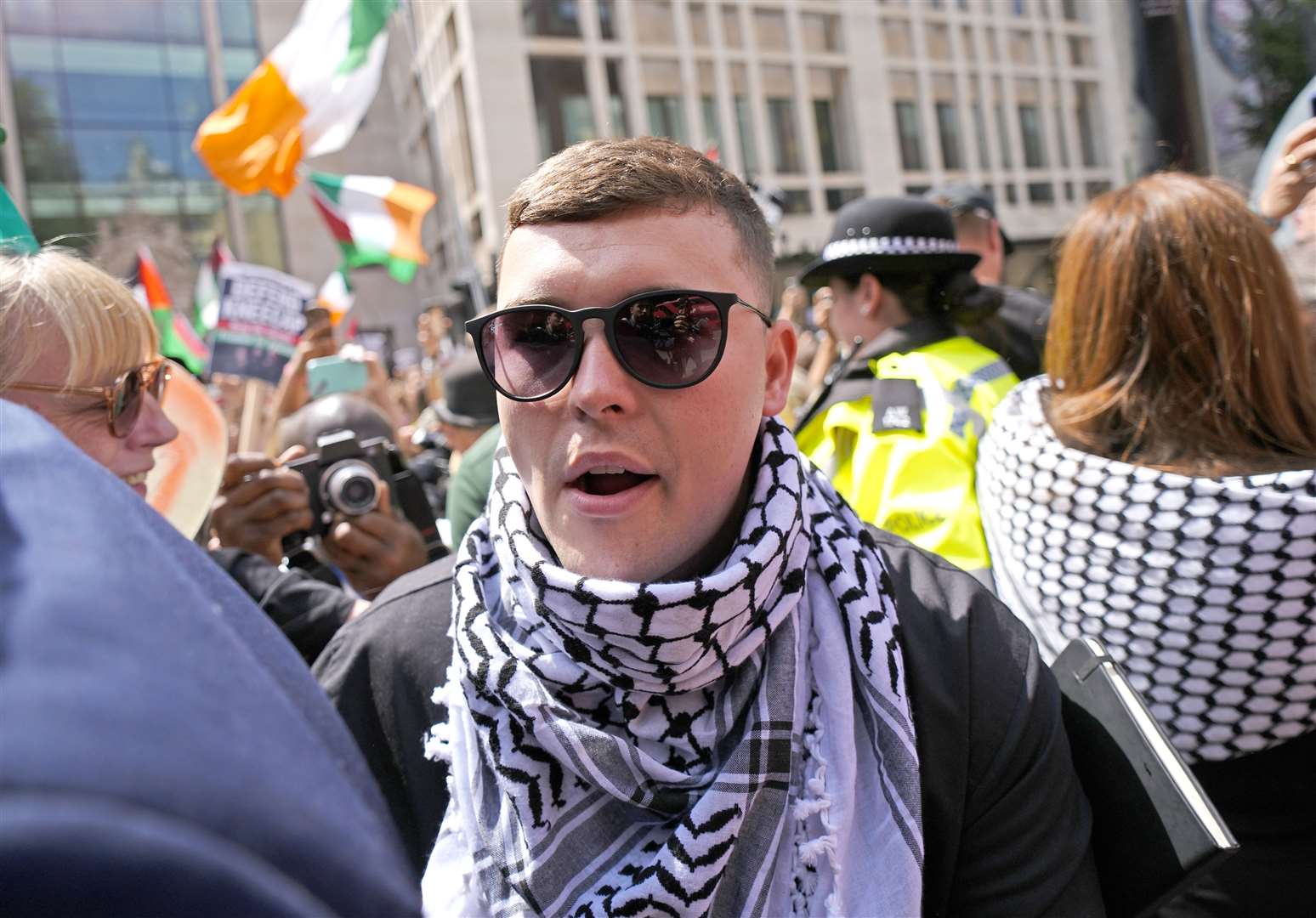 Kneecap’s Liam Og O Hannaidh leaves Westminster Magistrates’ Court in London, through a crowd of supporters after he appeared charged with a terrorism offence (Jordan Pettitt/PA)