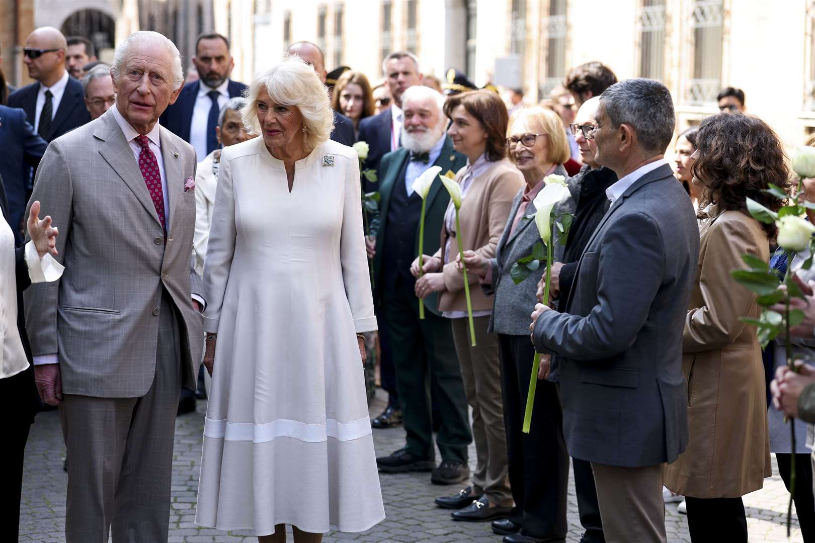 The King and Queen were greeted in Ravenna by wellwishers holding arum lilies and white roses (Phil Noble/PA)