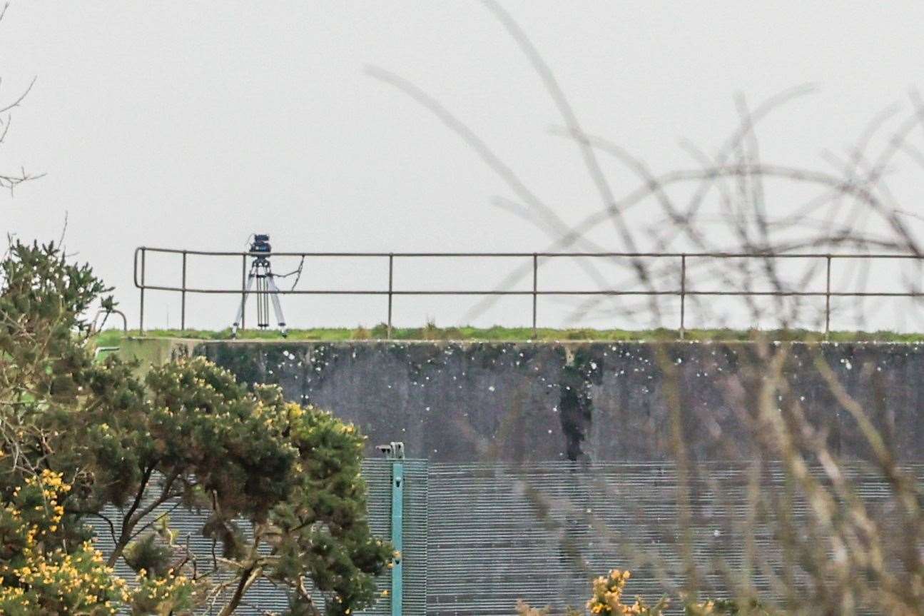Camera tripod visible on top one of the concrete shelters