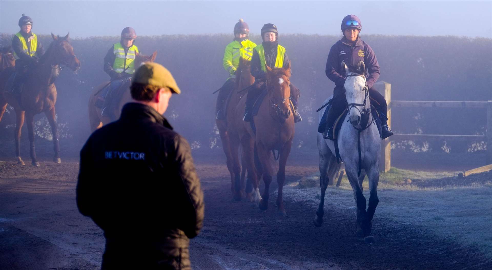 Jamie Snowden watches on from the gallops in Lambourn