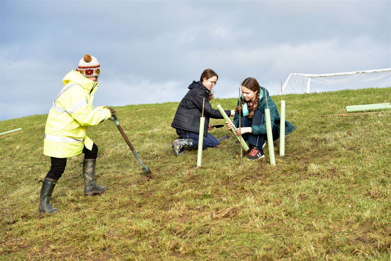 Pupils planting trees near the school field