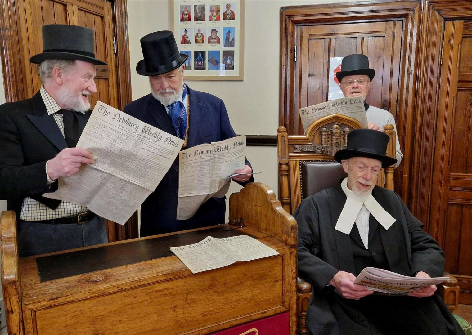 Cast members reading historic editions of the Newbury Weekly News
