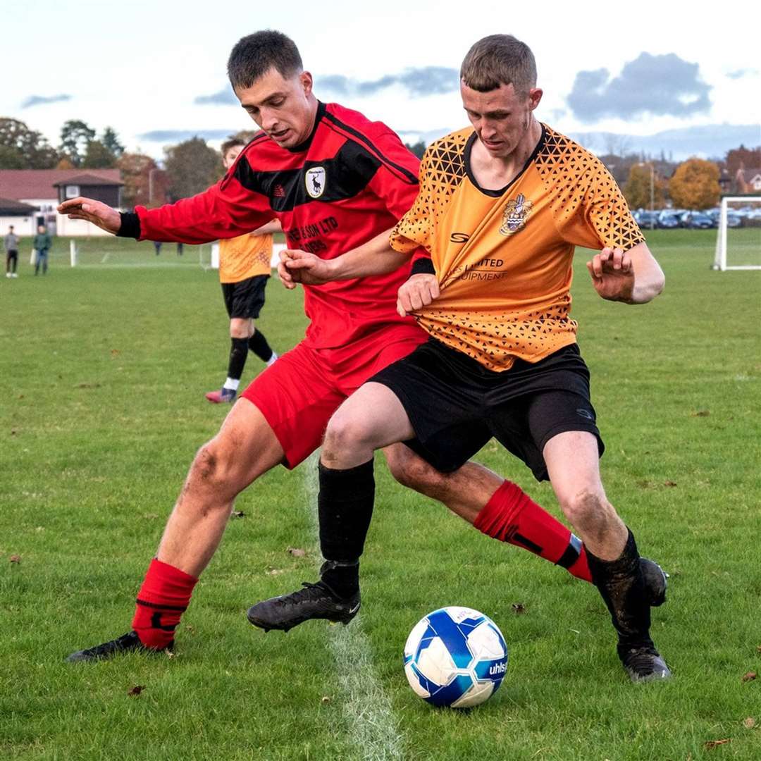 Newbury FC's Liam Smith battles for possession - Photo: Newbury FC