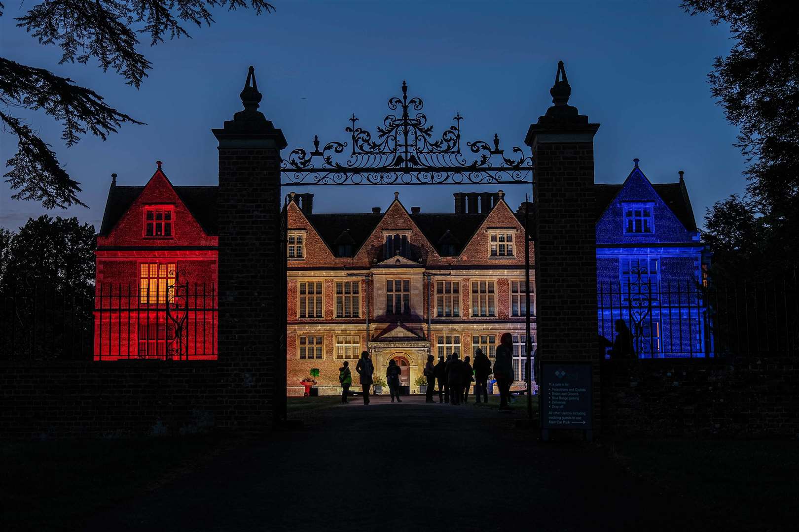 Shaw House lit up in red, white and blue