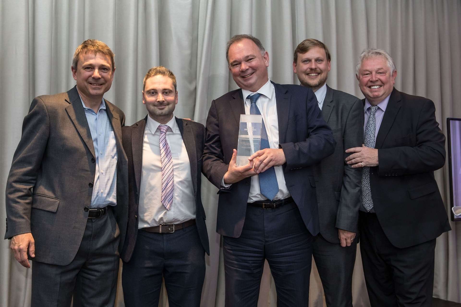 Newbury Weekly News editor Andy Murrill, centre, collects the award with news editor Dan Cooper, second left, and photographer Phil Cannings, second right
