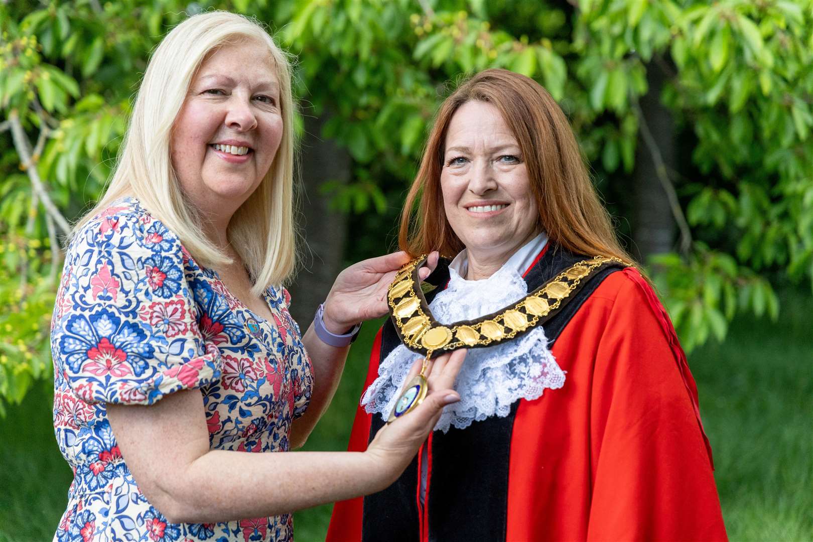 Suzanne Adamantos, left, when she was presenting mayor’s chain to new Mayor Petra Pemberton