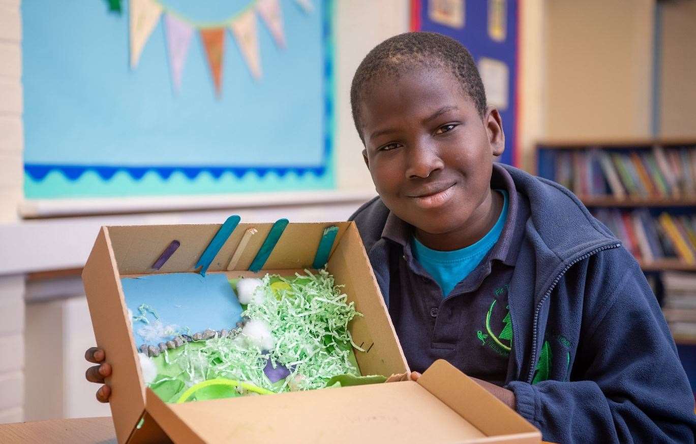 Fikunmi Daniel with the competition-winning shoebox at Fir Tree Primary School