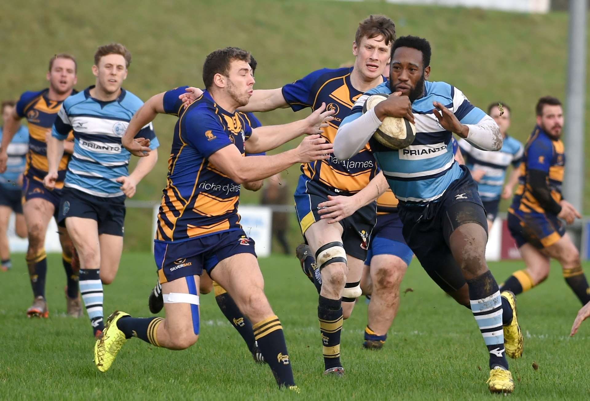 Newbury Blues' Ryan Davis bursts forward against Swindon