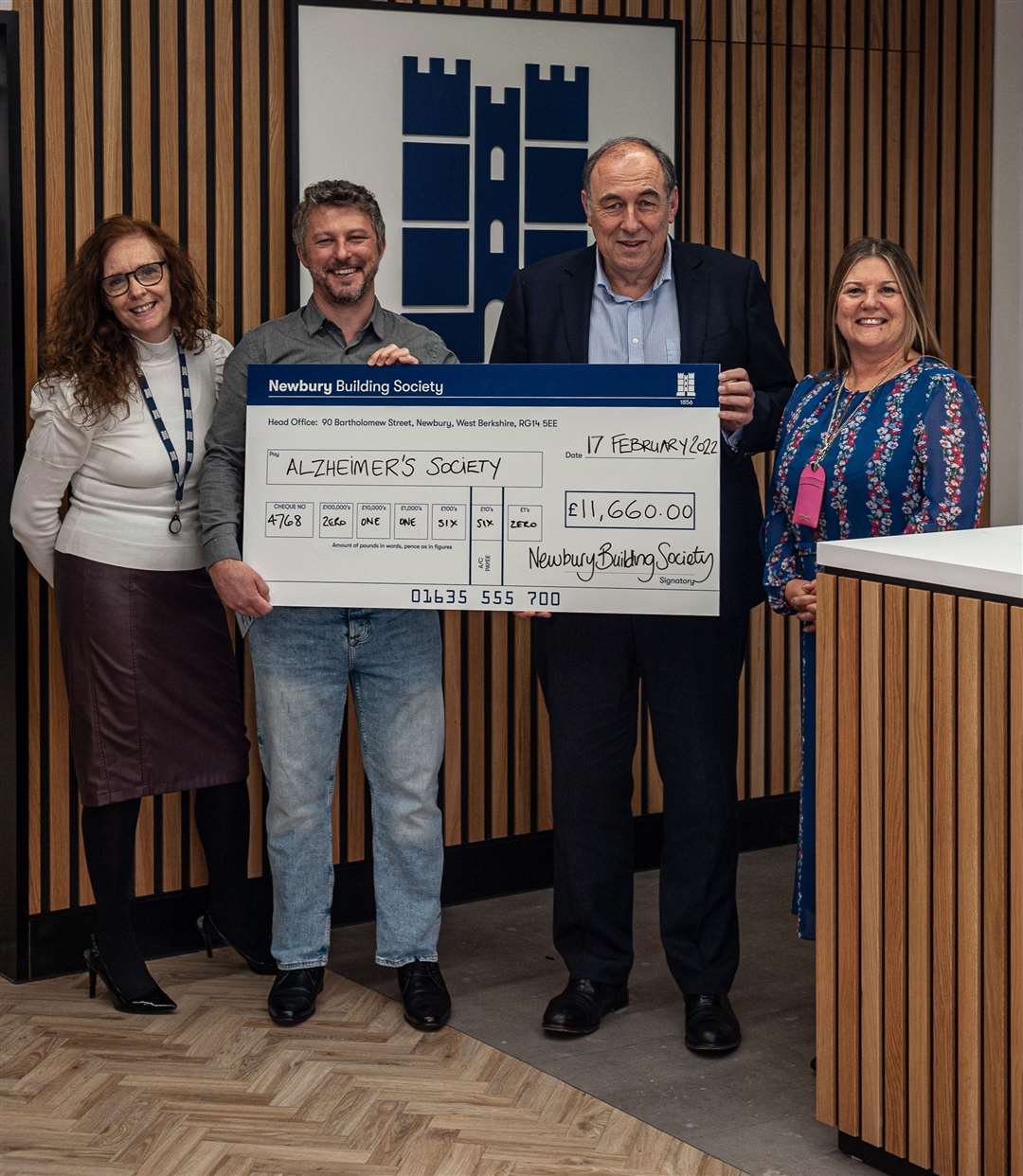 Roland Gardner, Traci Sharp, and Debbie Springer presenting the sizeable cheque to Tim Waters from Alzheimer’s Society