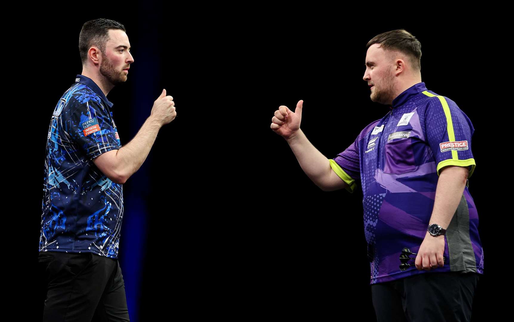 Luke Humphries and Luke Littler bump fists during their Premier League Final - (PDC)