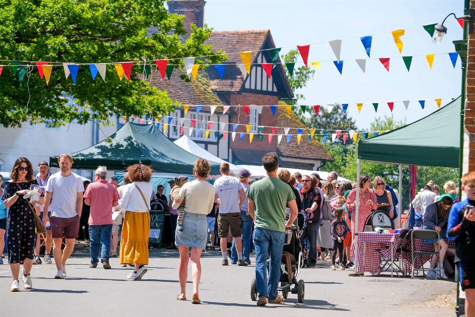 Crowds enjoying the sunshine in the bustling village centre