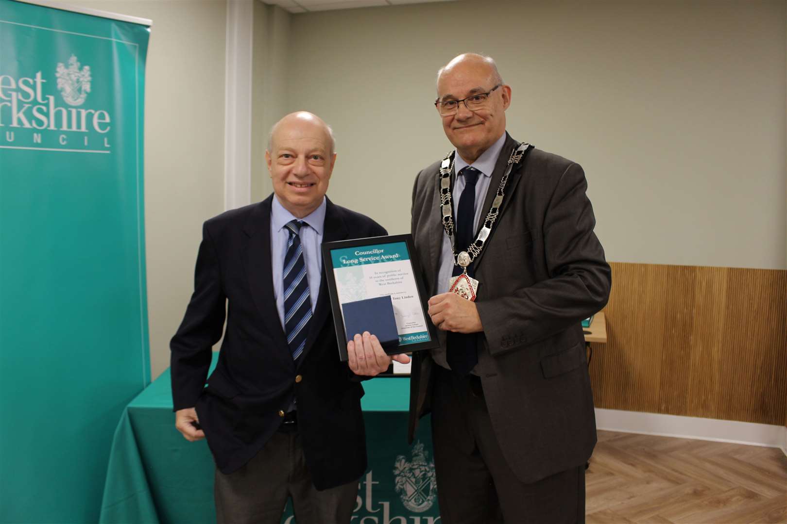 Tony Linden gets his long service award from chairman Jeremy Cottam