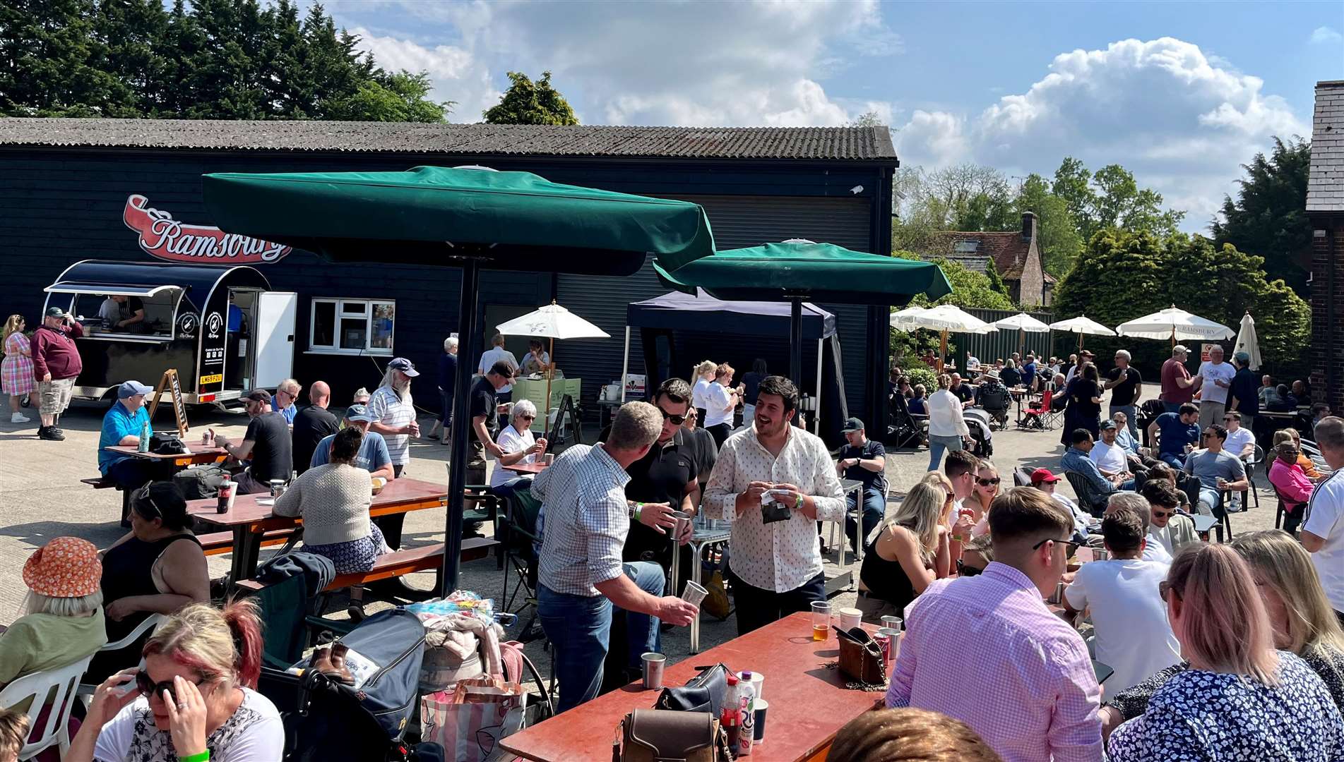Crowds gather under the sun to enjoy a wide variety of food and beer