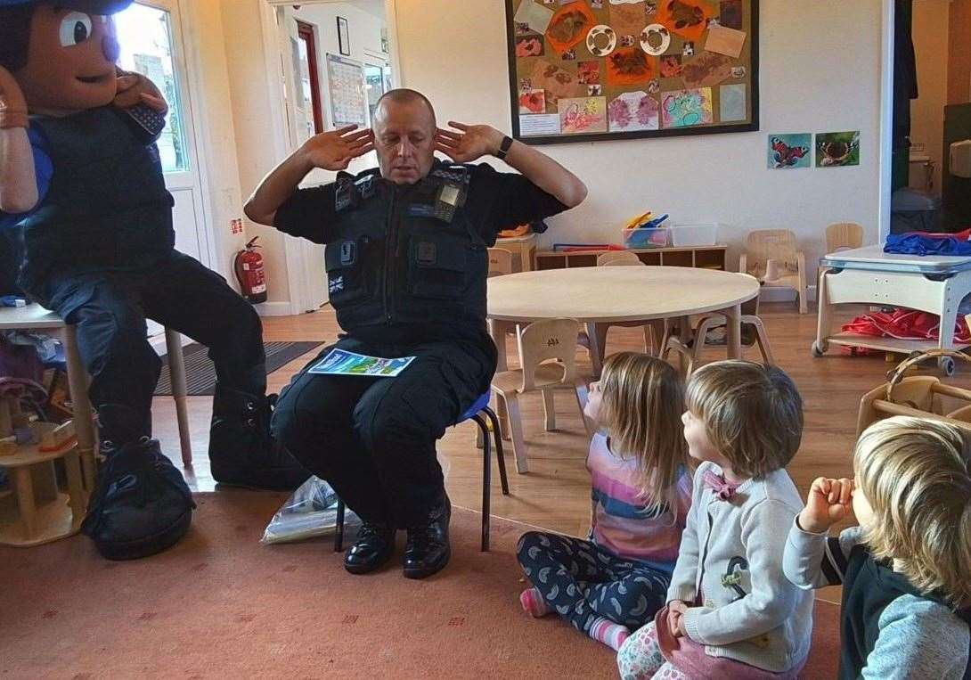 PCSO Alex and PCSO mascot John teach pupils about road safety