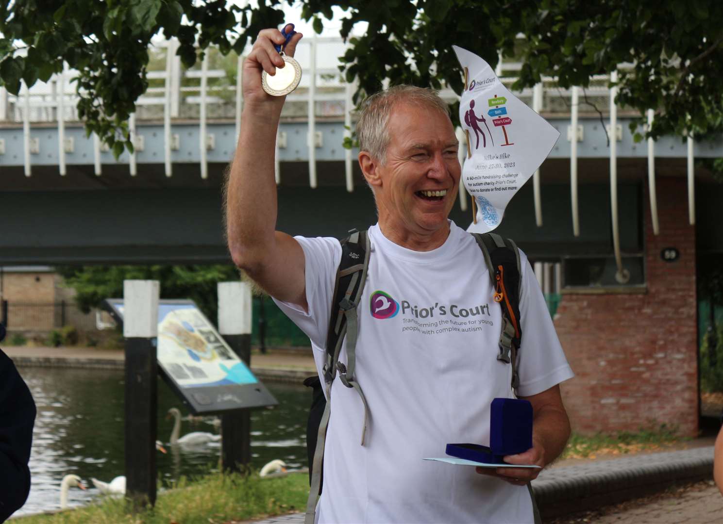Mr Robinson presented with a medal at the end of his walk