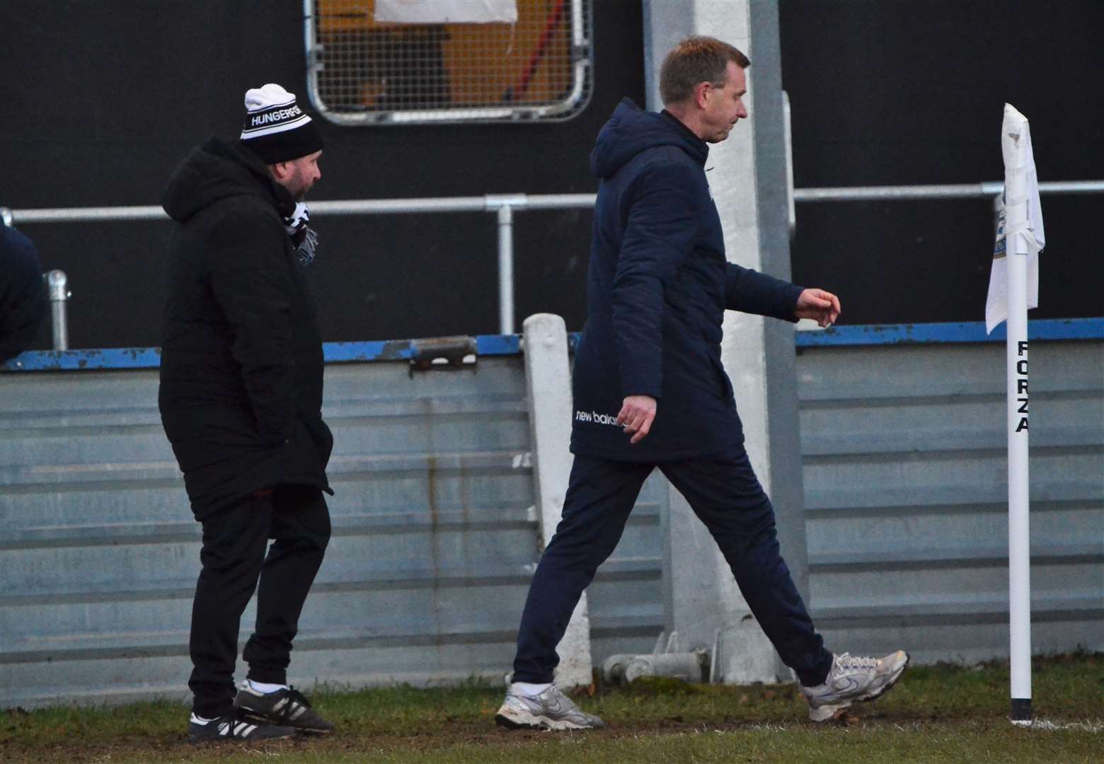 The two managers walk back to the changing rooms after seeing red
