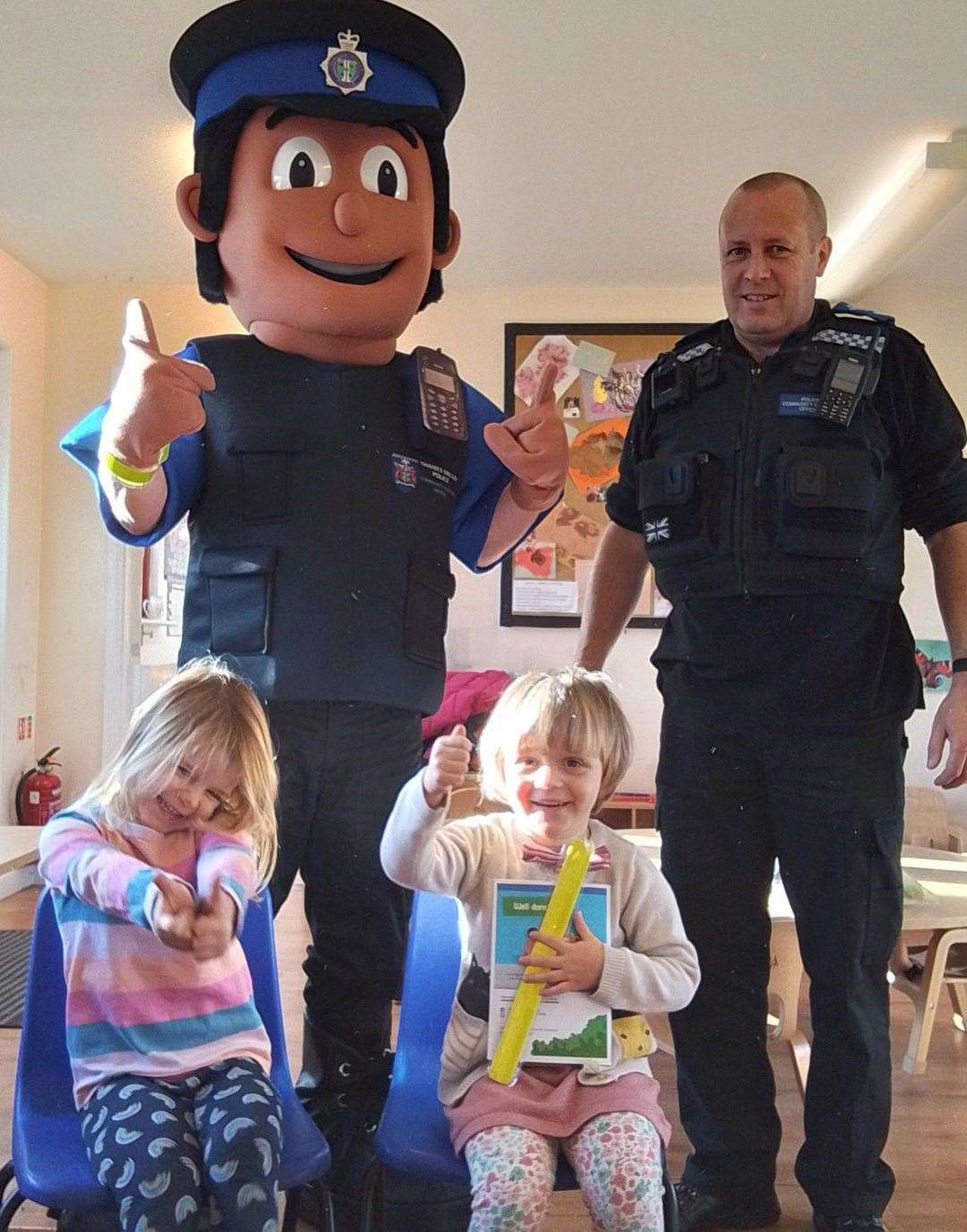 PCSO Alex and PCSO mascot John teach pupils about road safety